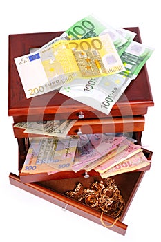 Money and gold in a wooden casket