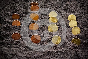 Money growth. Euro coins growing from soil. Selective focus