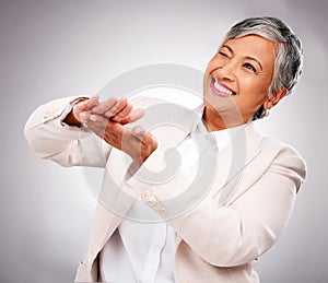 Money, hands and wink by senior business woman in studio happy with investment, growth or payment on grey background