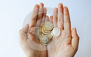 Money in the hands of a woman on a white background