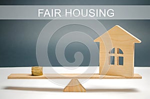 Money and house on the scales with the inscription Fair housing. Home appraisal. Property valuation. Housing evaluator. Fair trade photo