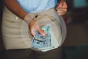 Money in human hands, women giving dollars