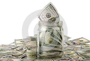 Money in the jar placing on US dollar banknotes photo