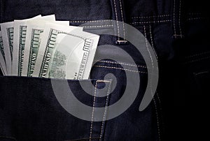 Money in jeans pocket, several hundred-dollar bills