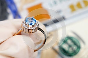 Money and jewelry as golden ring, pawn shop and buy and sell concept, on wooden background