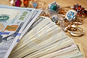 Money and jewelry, pawn shop and buy and sell precious metals concept, golden rings, necklace bracelet o wooden background