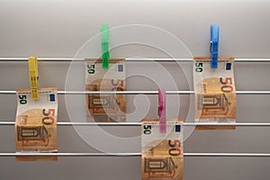 Money laundering on clothesline isolated on white background