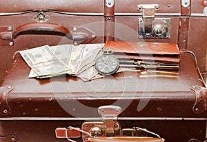 Money lays on an old suitcase photo