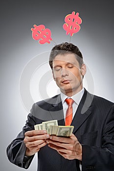 Money-maker. Funny businessman with a dollar hornes on the head