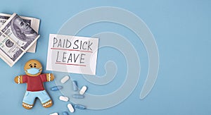 Money, medicine and gingerbread man in a mask inscription paid sick leave