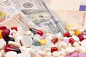 Money with medicine pills. High Cost of Medicine and Healthcare