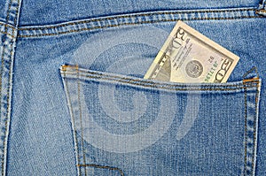 Money in my jeans pocket, fifty dollars in the back pocket of blue jeans. Wealth and prosperity concept. Place for text