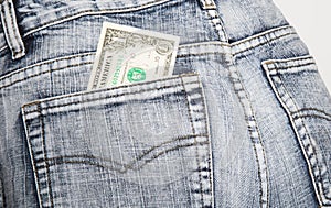 Money, the note of one dollar, in a hip-pocket of blue jeans