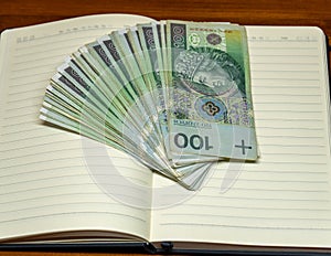 money on a notebook polish zloty hundreds currency