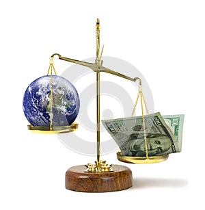 Money outweighing the earth on a scale representing greed & political corruption money being more powerful and important