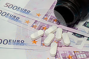 Money pills. Medicine pills on euro bills white medicine tablets on money. Covid-19 coronavirus pills are in euro money