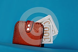 Money in a red purse on a blue background