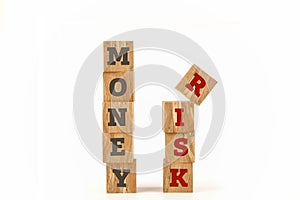 Money and Risk word written on cube shape.