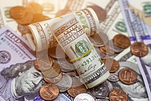 Money roll and coins usa on dollar background. Financial concept.
