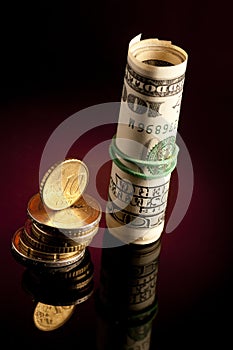 Money roll with US dollars, and euro coins