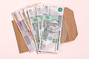 Money Russia. A stack of cash and an envelope on a white background. The concept of salary in an envelope.