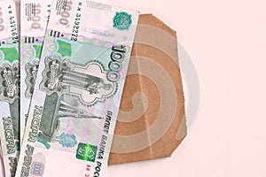 Money Russia. A stack of cash and an envelope on a white background. The concept of salary in an envelope.