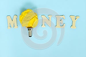 Money saving, budget, spending and investment ideas and tips concept. Word money with bright yellow crumpled paper