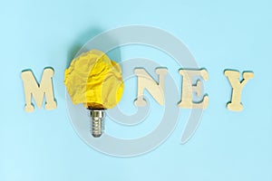 Money saving, budget, spending and investment ideas and tips concept. Word money with bright yellow crumpled paper