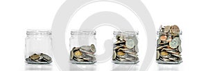 Money saving, glass jar arrange with coins inside growing, on white background photo