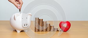 Money Saving, Health Insurance, Medical, Donation and Financial concepts. coins stack and piggy bank with red Heart shape, Money