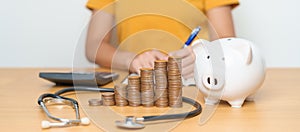 Money Saving, Health Insurance, Medical, Donation and Financial concepts. woman with coins stack and piggy bank and stethoscope,