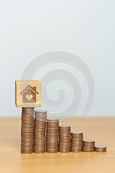 Money Saving, Property investment, House Mortgage and Real Estate Financial concepts. coins stack with Home block, Money stack