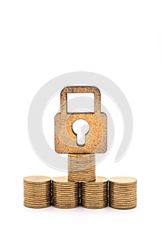 Money and Security Concept. Closeup of  wooden master key lock icon with pile and stack of gold coins on white background