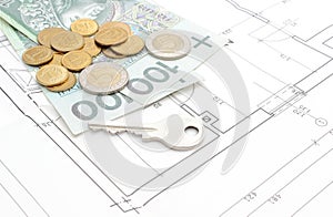 Money and silver key lying on the housing plan
