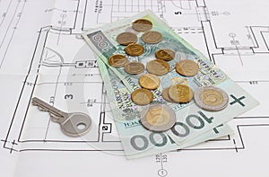 Money and silver key lying on the housing plan