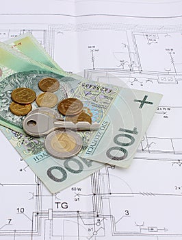 Money and silver key lying on the housing plan