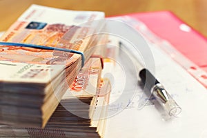 Money stacks - one and a half million russian rubles and signed contract photo