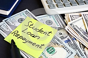 Money for Student Loan Repayment on a table. photo