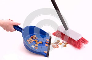 Money sweeps up in a dustpan