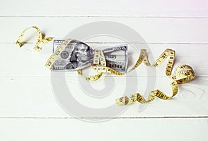 Money with a tape measure. Dollars photo. Inflation rates. Price growth. Greedy corruption concept. Bribe idea