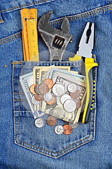 Money and tool in jeans pocket