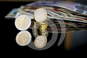 Money of United Kingdom close up on black background. Pounds UK 10 and 20 note and euro money coins