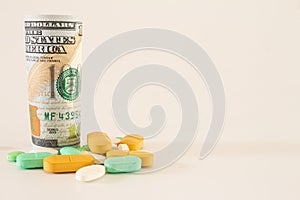 Money from the United States with vibrantly colored medicines on a neutral white background. Concept of health cost. Concept of