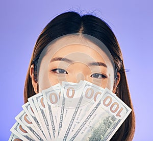 Money, winner and woman cover face on purple, studio background for winning, cash fan or financial loan. Lottery, bank