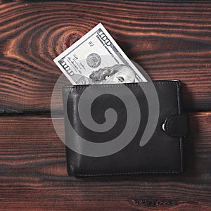 Money in your wallet. Dollars on a wooden background