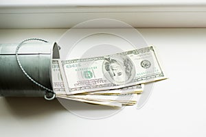 Moneybox, dollars in bucket on white window.light background. place for text. top view. a lot of money