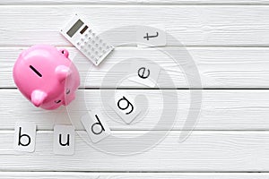 Moneybox in shape of pig and calculator for business budget on white wooden background top view mock-up