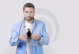 moneyless guy with wallet in studio with copy space. moneyless guy with wallet at hand.