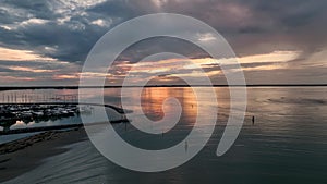 MONFALCONE, ITALY - APRIL, 2023: Sailing yacht moored off the coast Adriatic sea in Italy at sunset. Drone aerial view