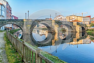 Monforte de Lemos, Galicia, Spain. Old stone bridge Puente Vella, Puente Romano at sunrise.